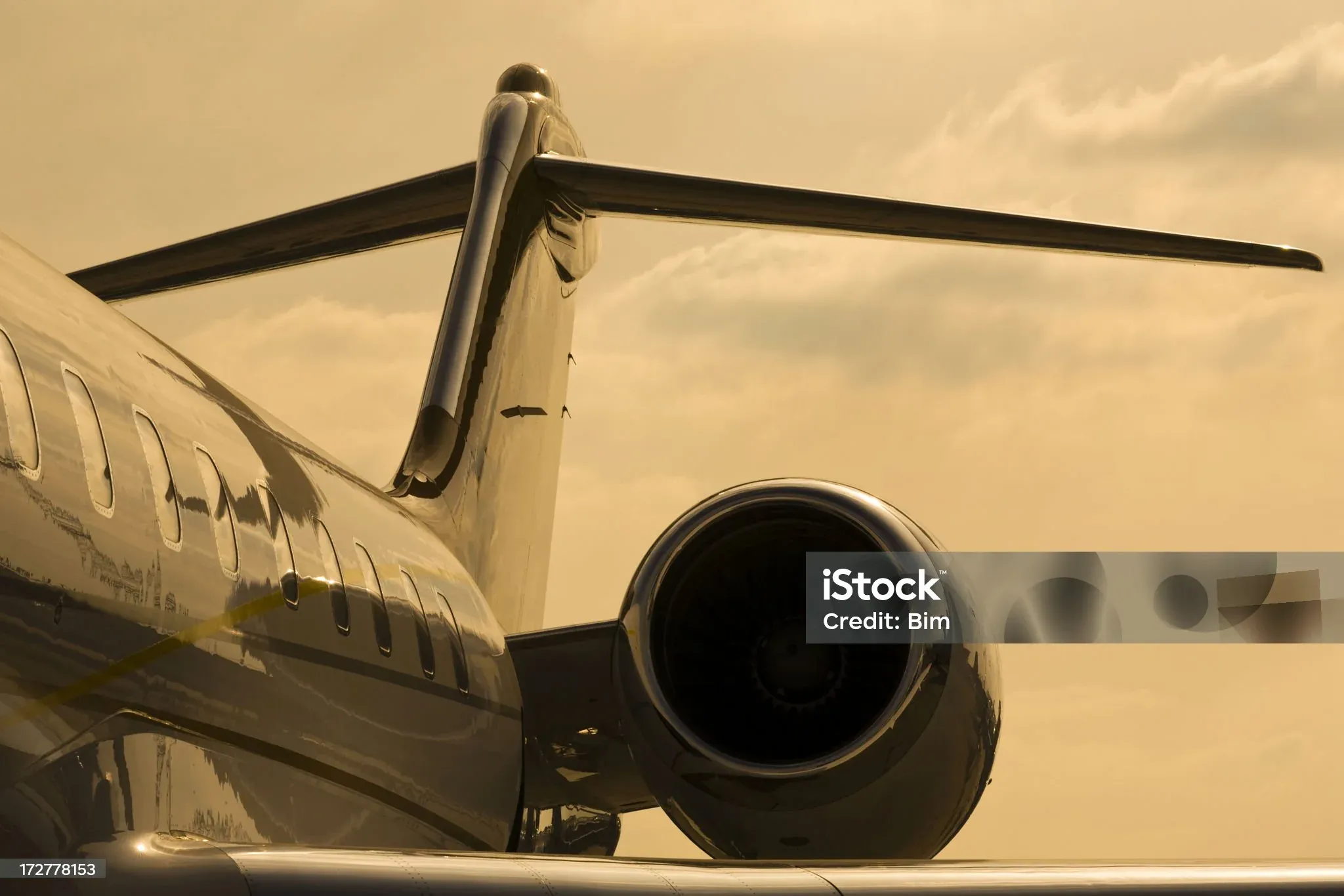 Private jet on the tarmac at sunset