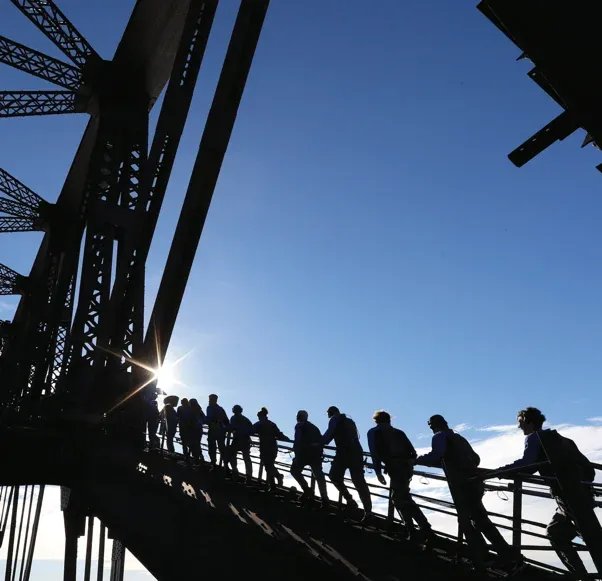 Climbers silhouetted on the Harbour Bridge arch