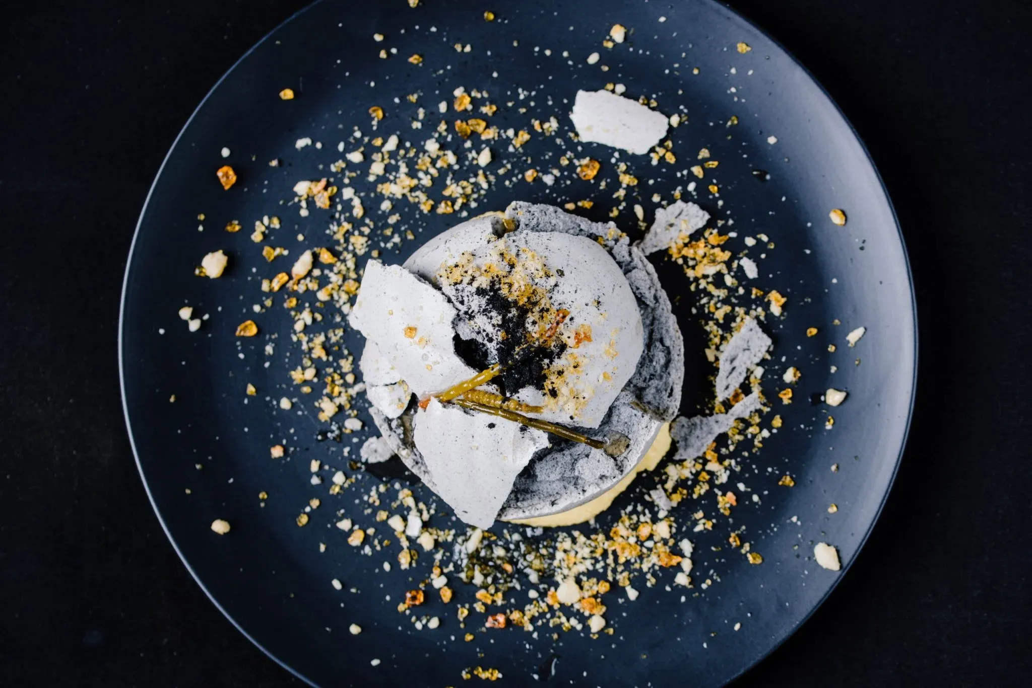A plated dessert on a dark plate