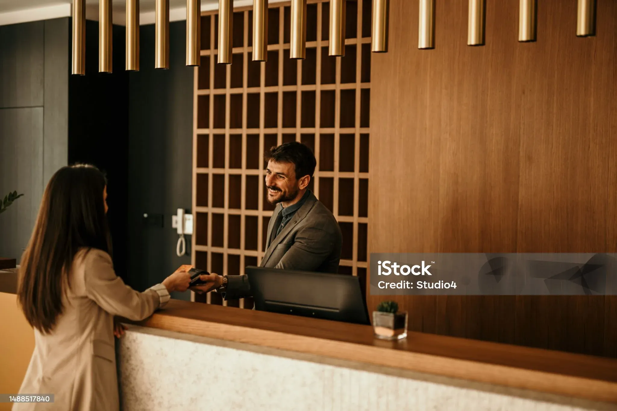 Guests checking in at a hotel reception
