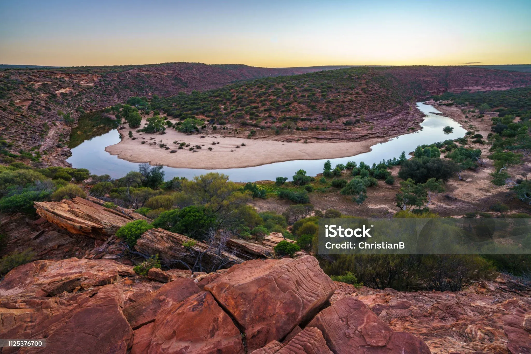 A river winding through red cliffs