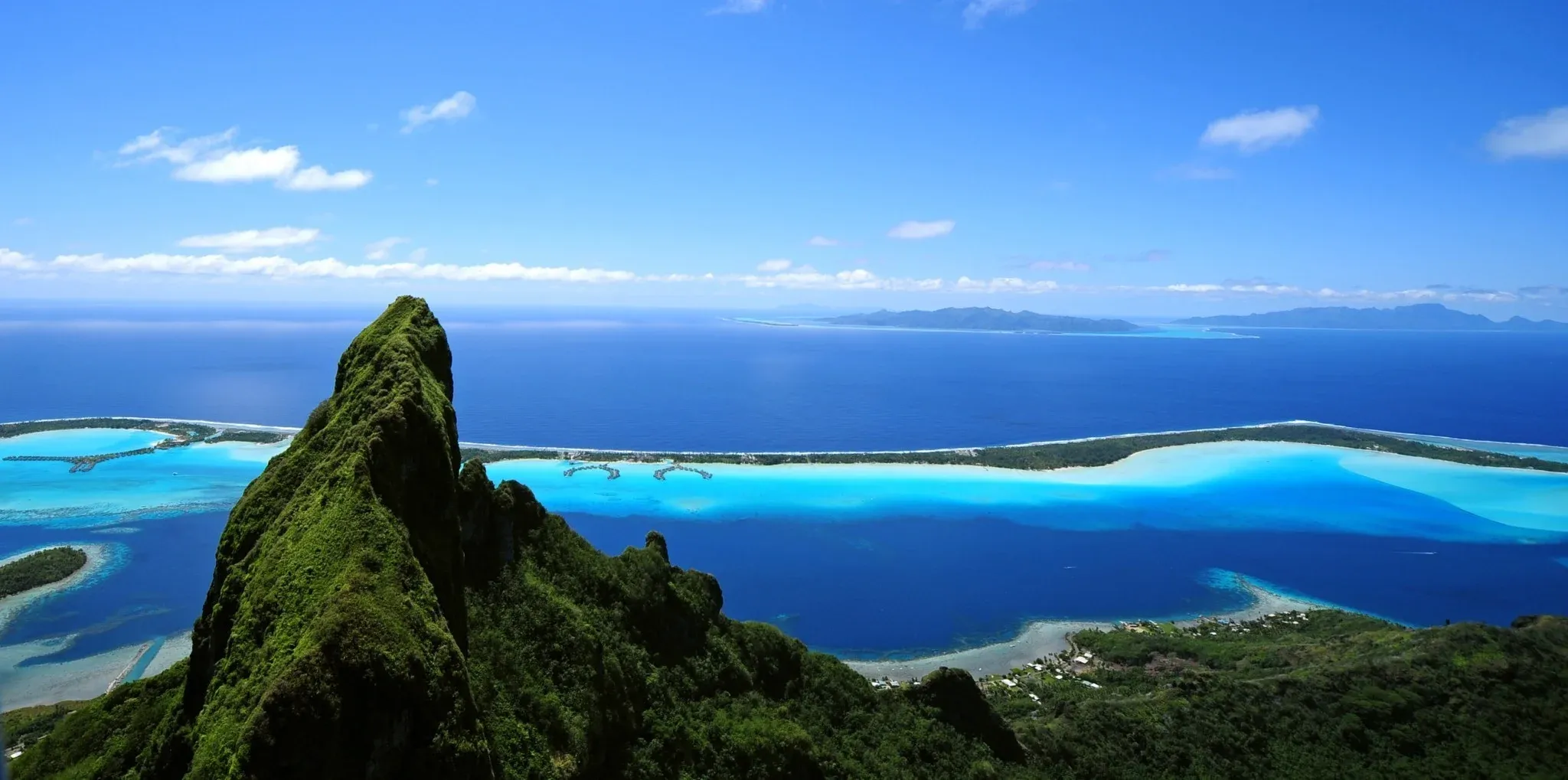 Volcanic peak above a turquoise lagoon