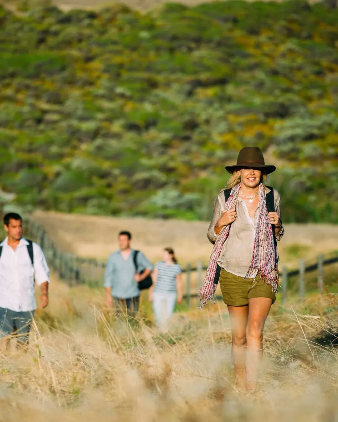 Guests walking through long grass